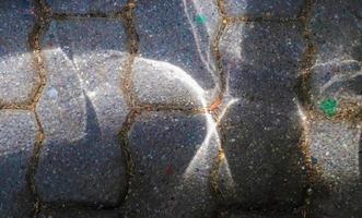 Caustic light effects from refraction in glass on an ashalt ground. photo