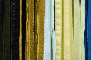 Detailed close up view on samples of cloth and fabrics in different colors found at a fabrics market photo