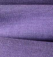 Detailed close up view on samples of cloth and fabrics in different colors found at a fabrics market photo