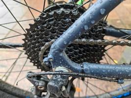 Selective focus close up view at a bicycle wheel with metal spokes photo