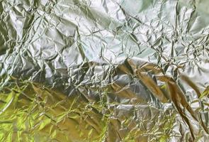 Detailed close up texture of an aluminum foil surface in different colors. photo