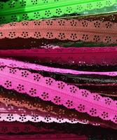 Detailed close up view on samples of cloth and fabrics in different colors found at a fabrics market photo