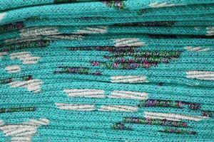 Detailed close up view on samples of cloth and fabrics in different colors found at a fabrics market photo