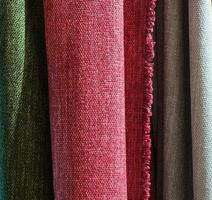 Detailed close up view on samples of cloth and fabrics in different colors found at a fabrics market photo
