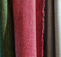 Detailed close up view on samples of cloth and fabrics in different colors found at a fabrics market photo