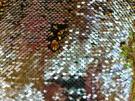 Close up view on samples of sequin fabric in golden colors photo