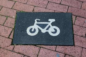 Painted bicycle signs on asphalt found in the city streets of Germany. photo