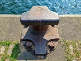 Different bollards in front of the water at the port of kiel. photo