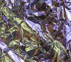 Detailed close up texture of an aluminum foil surface in different colors. photo