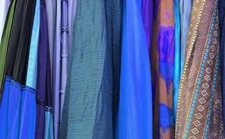 Detailed close up view on samples of cloth and fabrics in different colors found at a fabrics market photo