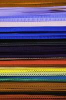 Detailed close up view on samples of cloth and fabrics in different colors found at a fabrics market photo