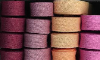 Detailed close up view on samples of cloth and fabrics in different colors found at a fabrics market photo