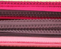 Detailed close up view on samples of cloth and fabrics in different colors found at a fabrics market photo