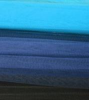Detailed close up view on samples of cloth and fabrics in different colors found at a fabrics market photo