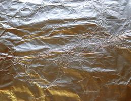 Detailed close up texture of an aluminum foil surface in different colors. photo