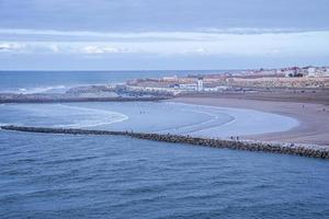 Scenic view of seascape with buildings at the coastline photo