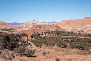 Scenic view of deserted mountain landscape and town with bushes photo