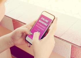 Woman hands using online banking on touch screen with smartphone. photo