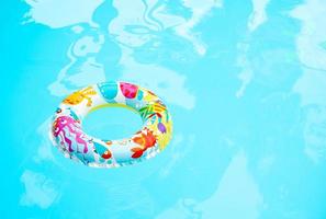 Colorful swim rings for children in the pool photo