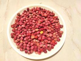 Berry like fruit - Kafal, the state fruit of Uttarakhand on a white plate on a light background. photo
