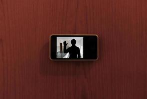 Monitor digital peephole watching a stranger outside the door photo