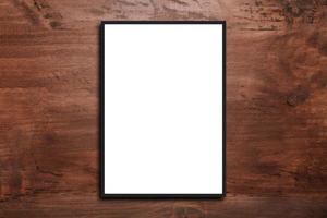 Mock up blank poster picture frame on wood wall photo