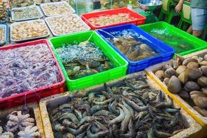 Variety of fresh seafood on market. Fresh salmon, sea bass, red snapper, mackerel, crab, lobster, shrimp, black mussels, oyster, scallop and octopus on ice in market photo