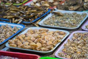 Variety of fresh seafood on market. Fresh salmon, sea bass, red snapper, mackerel, crab, lobster, shrimp, black mussels, oyster, scallop and octopus on ice in market photo