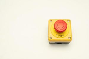 Stop Button and the Hand of Worker About to Press it. emergency stop button. Big Red emergency button or stop button for manual pressing. photo