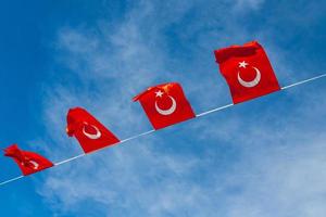 National flags of Turkey on a waving against a blue sky photo