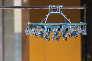 Close-up of a row of round empty hangers on railings in a store photo