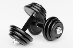 3d render illustration of a dumbbell with black plates, on a white background. Creative concept. photo