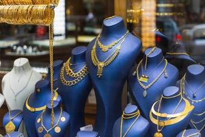 Showcase of a jewelry store with a huge selection of gold jewelry bracelets, chains, rings and earrings on a female relief photo