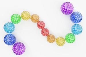 representación 3d bolas multicolores con agujeros en forma de serpiente. primer plano de las formas geométricas de la pelota sobre un fondo blanco foto