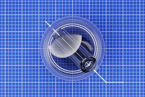 3D illustration drawing of a glass ball with a hole inside on a background of blue millimeter paper photo