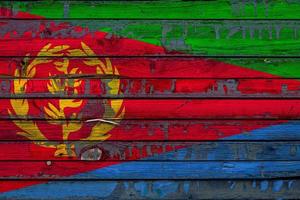 The national flag of Eritrea is painted on uneven boards. Country symbol. photo