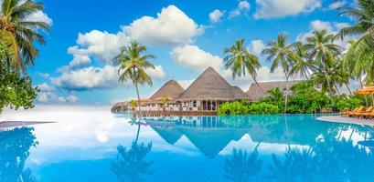 Summer vacation luxury resort with infinity pool reflection, palm trees sea view. Amazing travel landscape, photo