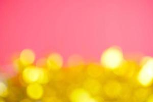 Abstract yellow bokeh and blurred on pink background photo