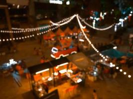Blurred images of thailand night streets food party in city, bokeh light,festival background. photo