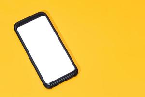 Template of Smart phone with blank white screen isolated on yellow background photo