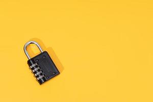Number Padlock isolated on yellow background. Copy space. Top view photo