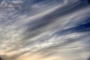 Evening sunset sky with blue and yellow clouds photo