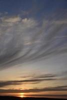 Evening sunset and sun with clouds and horizon photo