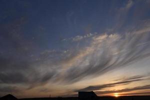 Evening sunset and sun with clouds and horizon photo