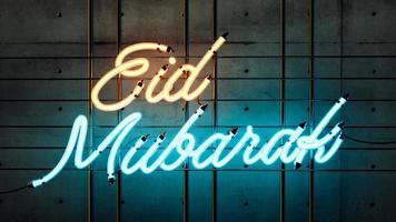 Eid Mubarak Bright Neon glowing yellow and blue sign with words dark concrete 3d illustration photo