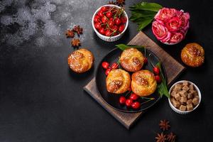 Fresh delicious rice flour muffins with cherries on a concrete background. Homemade pastries photo