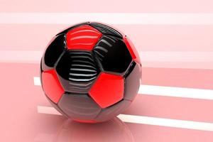 3D soccer ball with a glossy finish in red and black on a pink background photo