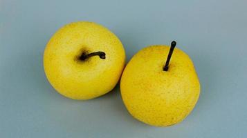 Top view of two pears with stem on gray background. Pears isolated on gray background. photo