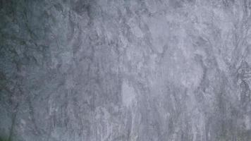 The old cement wall was weathered, the surface was scratched, the surface was scratched and damaged. For a mysterious retro-conservative background. photo