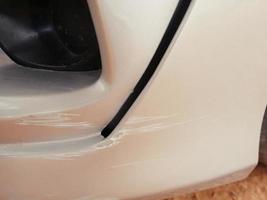 Scratches on the car after an accident damage to the front bumper. photo